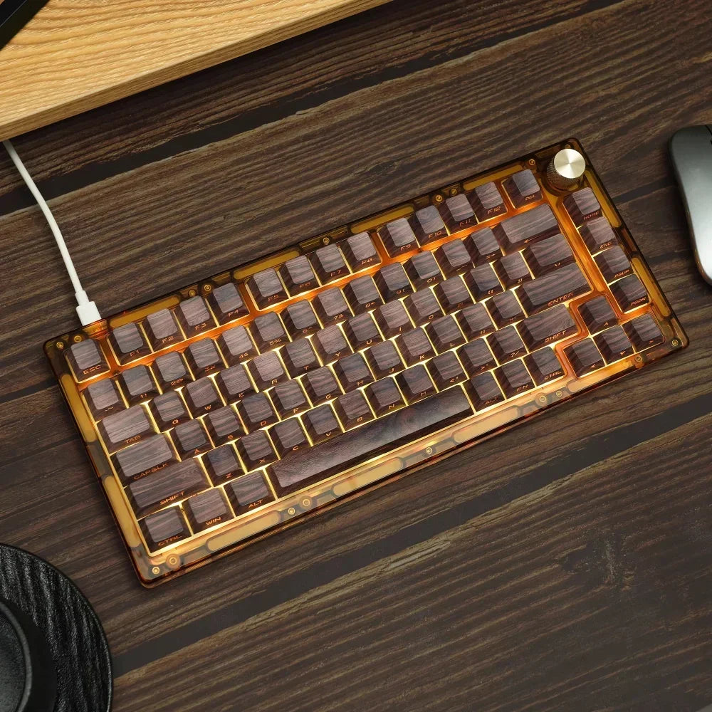 Cherry profile 136-key side-printed wood grain keycap set installed on a mechanical keyboard in a workspace setup with mouse and wooden desk at angle